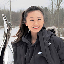 Headshot photo of Julia Wang in winter landscape