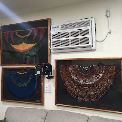 Three pieces from Rick San Nicolas' collection hang framed on a wall.