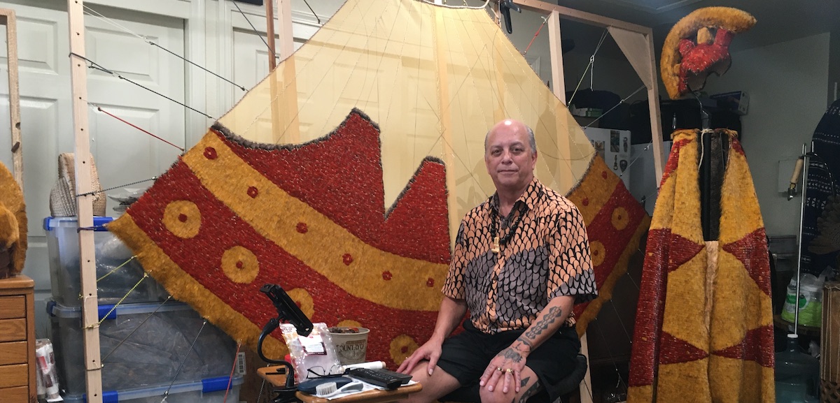 Rick San Nicolas sits at his featherworking studio.