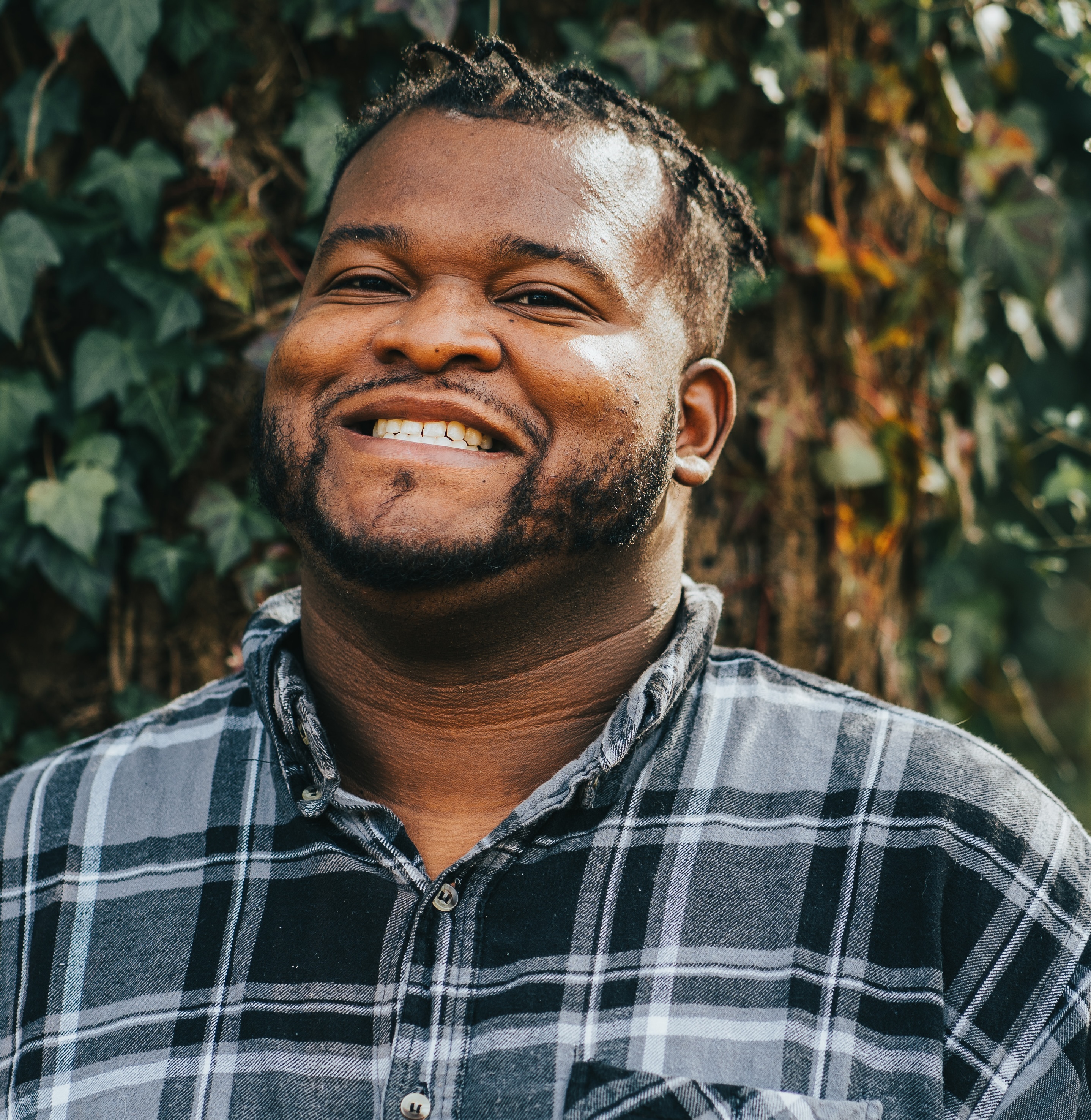 Alex Troutman makes a guest appearance on Bring Birds Back. Alex Troutman smiles in a photo surrounded by trees and leaves in the background.