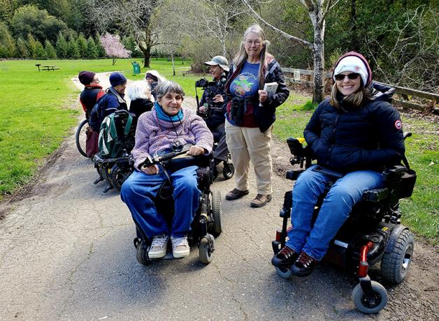 A group of people, some in wheelchairs, on a birding trip with the Golden Gate Bird Alliance.