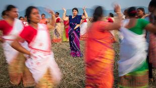 Purnima Devi Barman seen in the middle of a group of women dancing, the "Hargila Army"