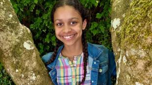 A photo of Piper Bayard smiling in nature.