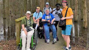 Birdability group members pose together on a birding trip with Bring Birds Back podcast host Tenijah Hamilton and BirdNote producer Mark Bramhill