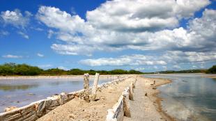 View of Cabo Rojo salt flats beneath a partly cloudy sky
