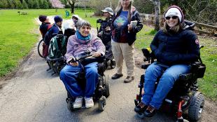 A group of people, some in wheelchairs, on a birding trip with the Golden Gate Bird Alliance.